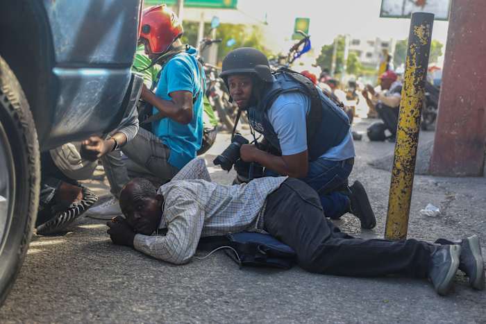 Residents in Haiti's capital stand with police in a battle to repel the latest gang attack