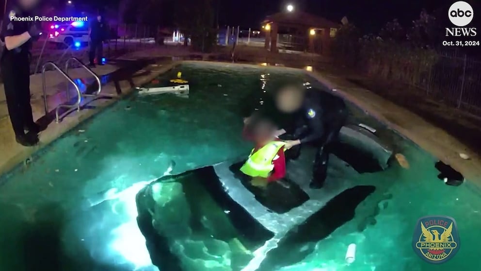 WATCH: Police officer rescues driver from car in swimming pool