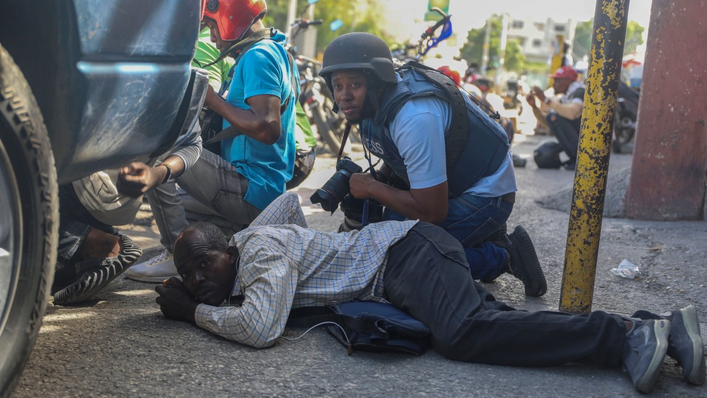 Haiti swears in a new leader as gangs shoot at a flight landing in the main airport