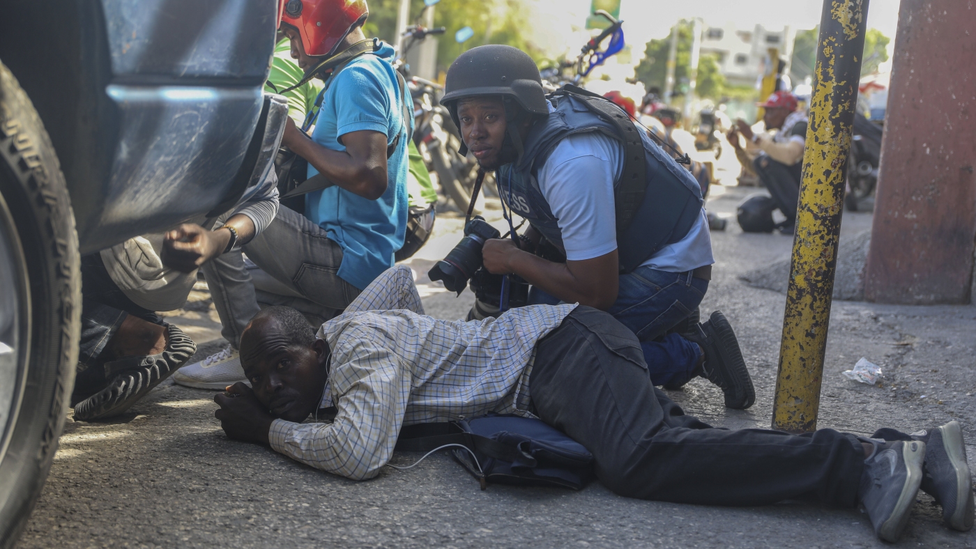 Haiti swears in a new leader as gangs shoot at a flight landing in the main airport