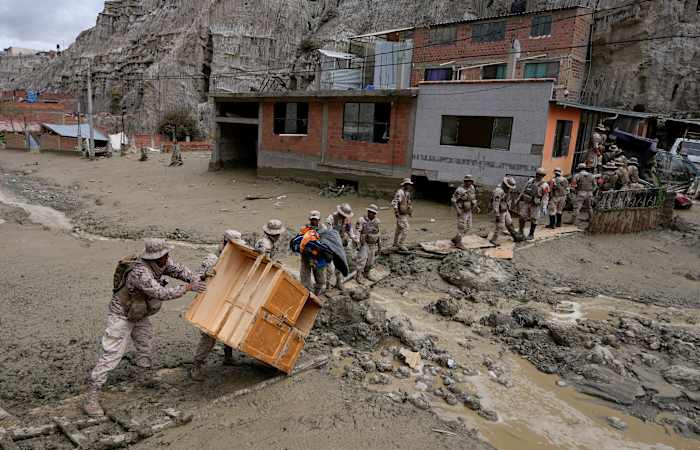 Heavy rains in Bolivia send mud crashing into the capital, leaving 1 missing and destroying homes