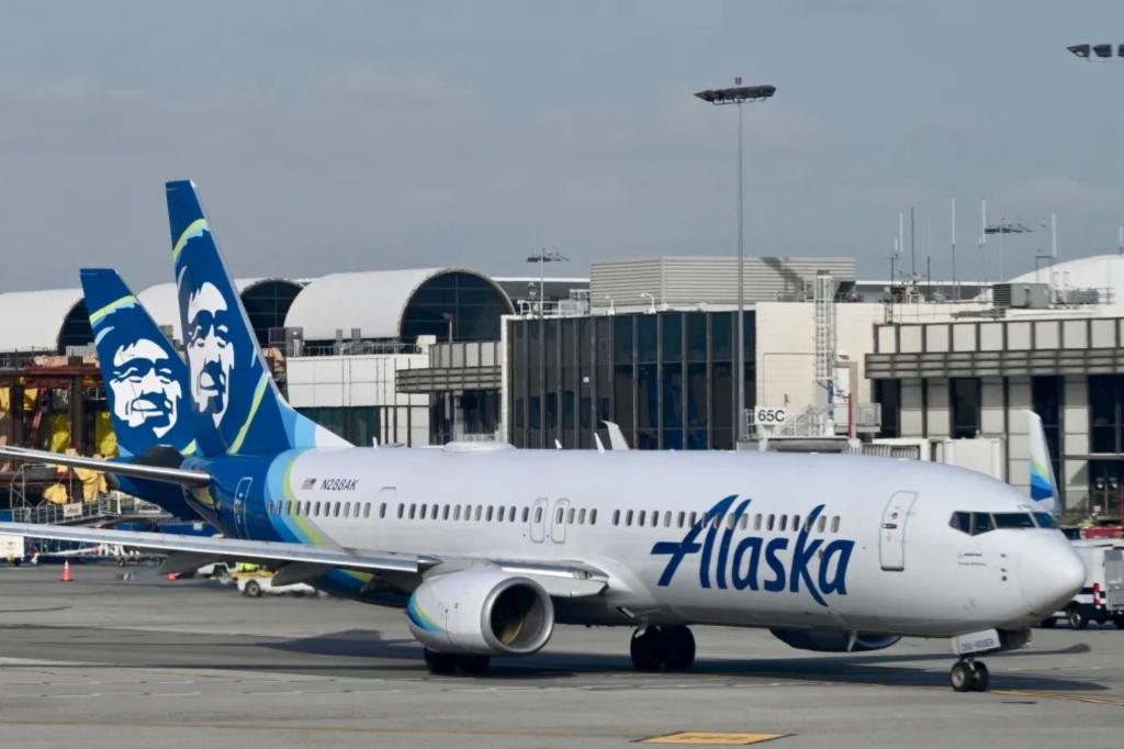 Alaska Airlines passenger opens emergency exit and climbs onto wing during deboarding