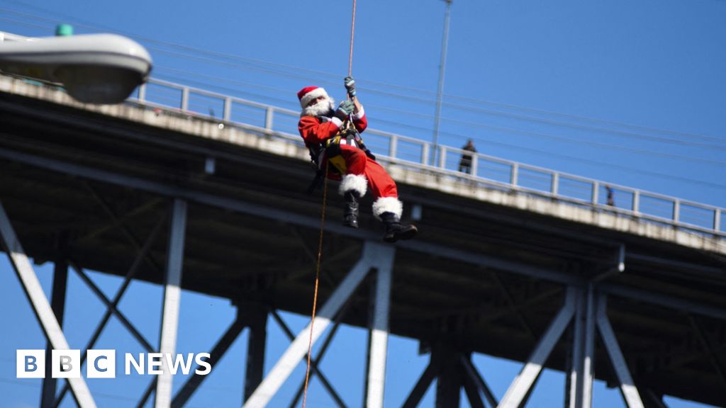 Watch: Abseiling Santa descends from Guatemala bridge to deliver toys