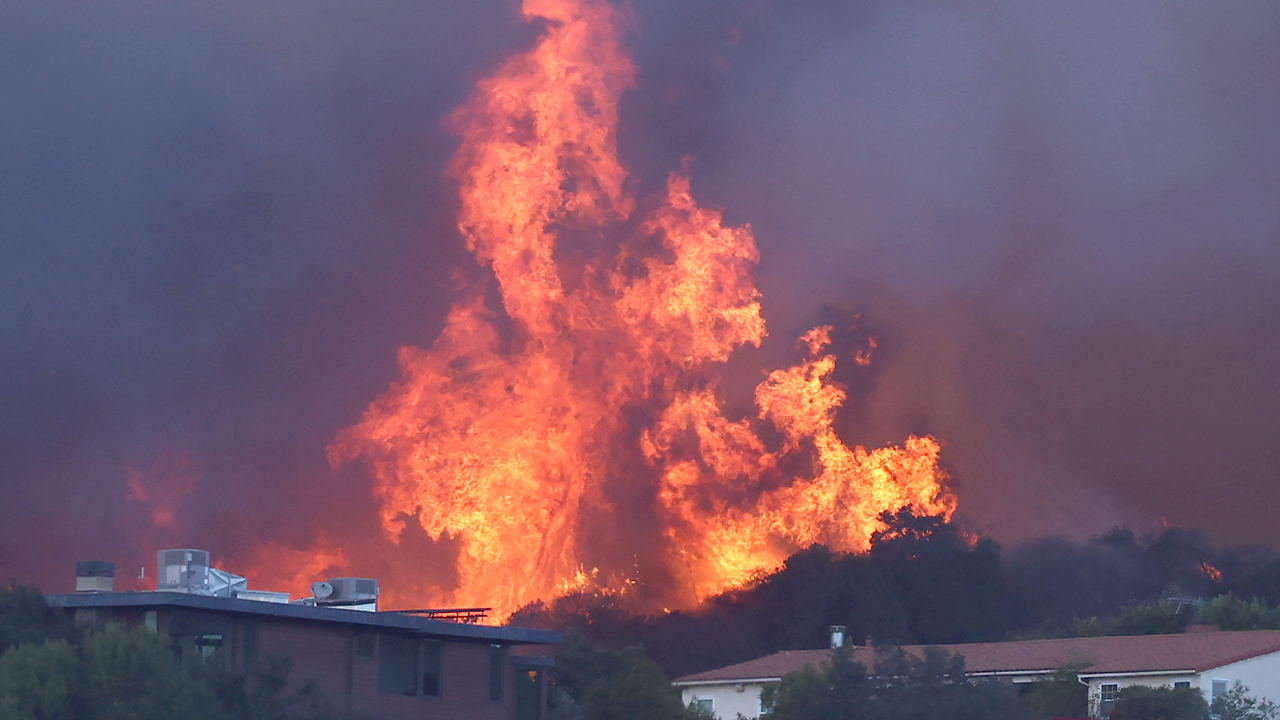 California wildfires rage across Los Angeles County, forcing thousands to evacuate their homes